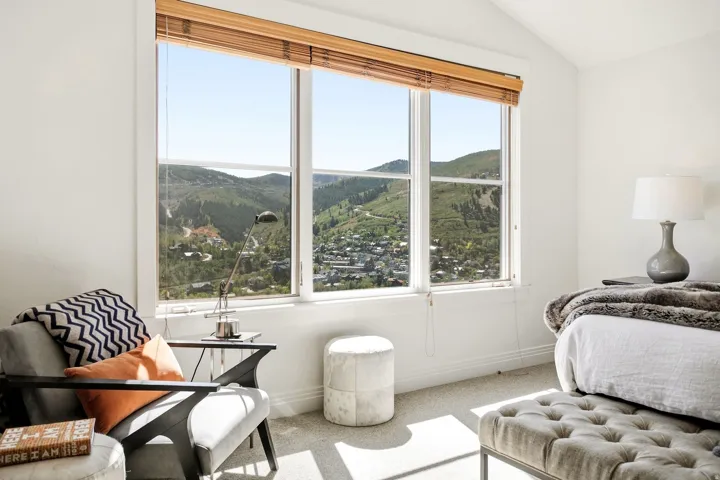 Expansive window with mountain and community scenery