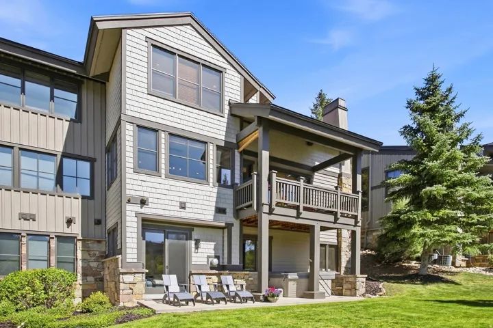 Multi-level exterior with shingle and vertical siding