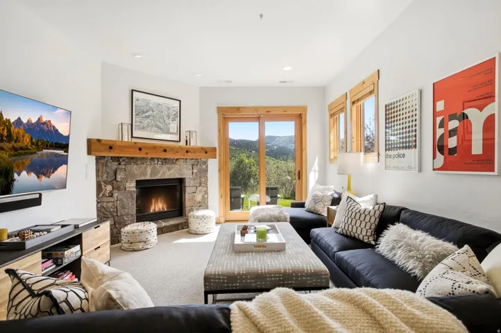 Stone-clad fireplace with a wood mantel