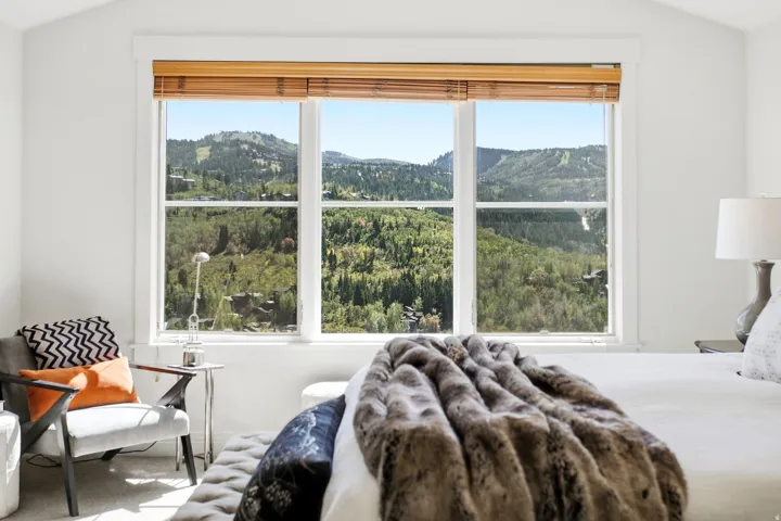 Vaulted ceiling with a large picture window showcasing mountain scenery
