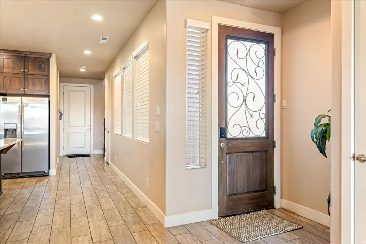 Hardwood entry door with decorative glass and ironwork