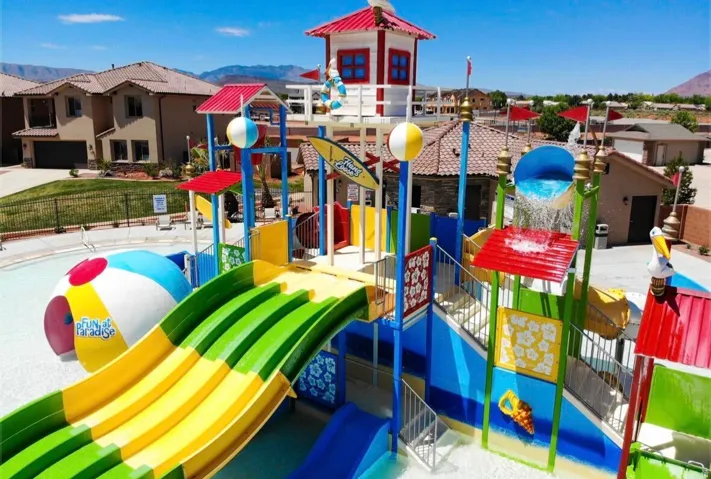 Water park structure featuring multiple slides, a water bucket feature, and a lifeguard tower