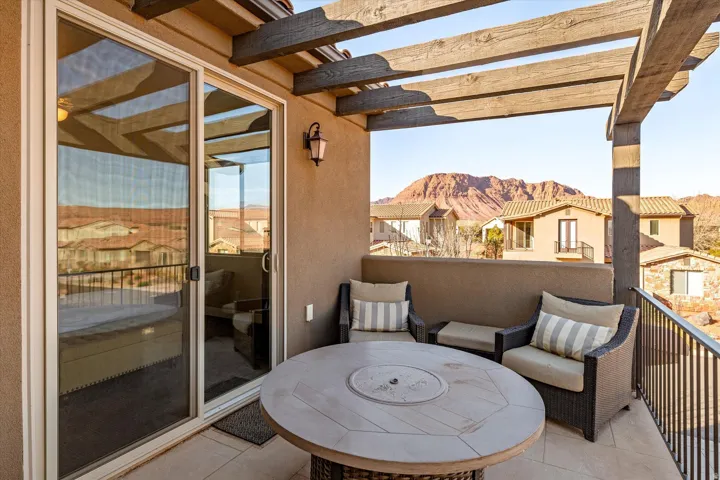 Covered balcony featuring a wood-look pergola