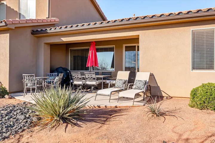 Covered patio with a concrete slab, multiple windows, and a sliding glass door