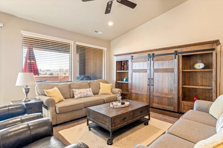 Vaulted ceiling with recessed lighting and ceiling fan