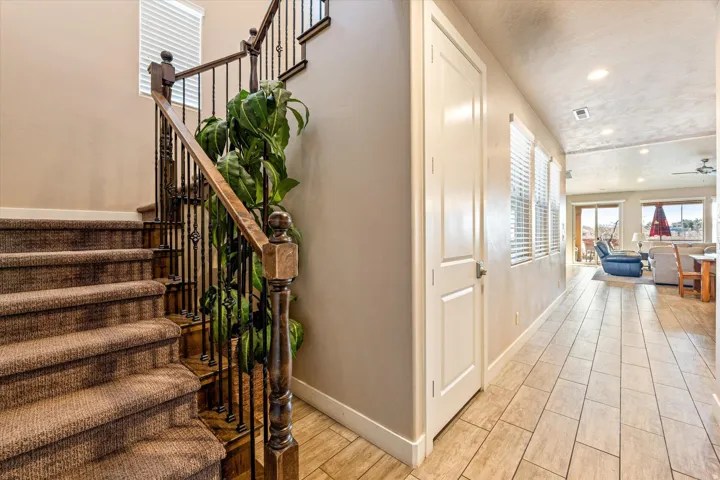 Staircase with wrought iron balusters and wood handrail