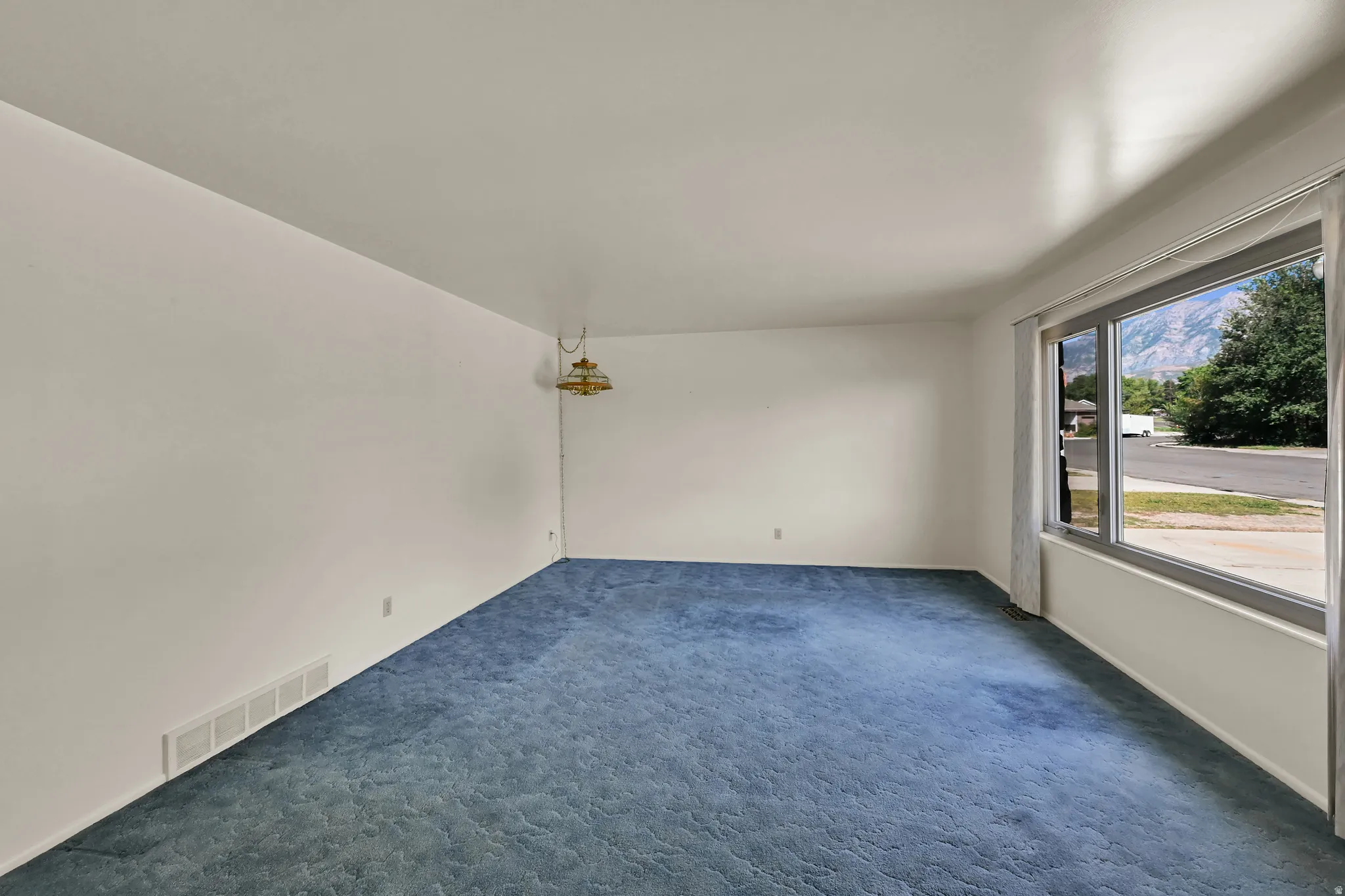 Expansive interior with wall-to-wall carpeting and a large window