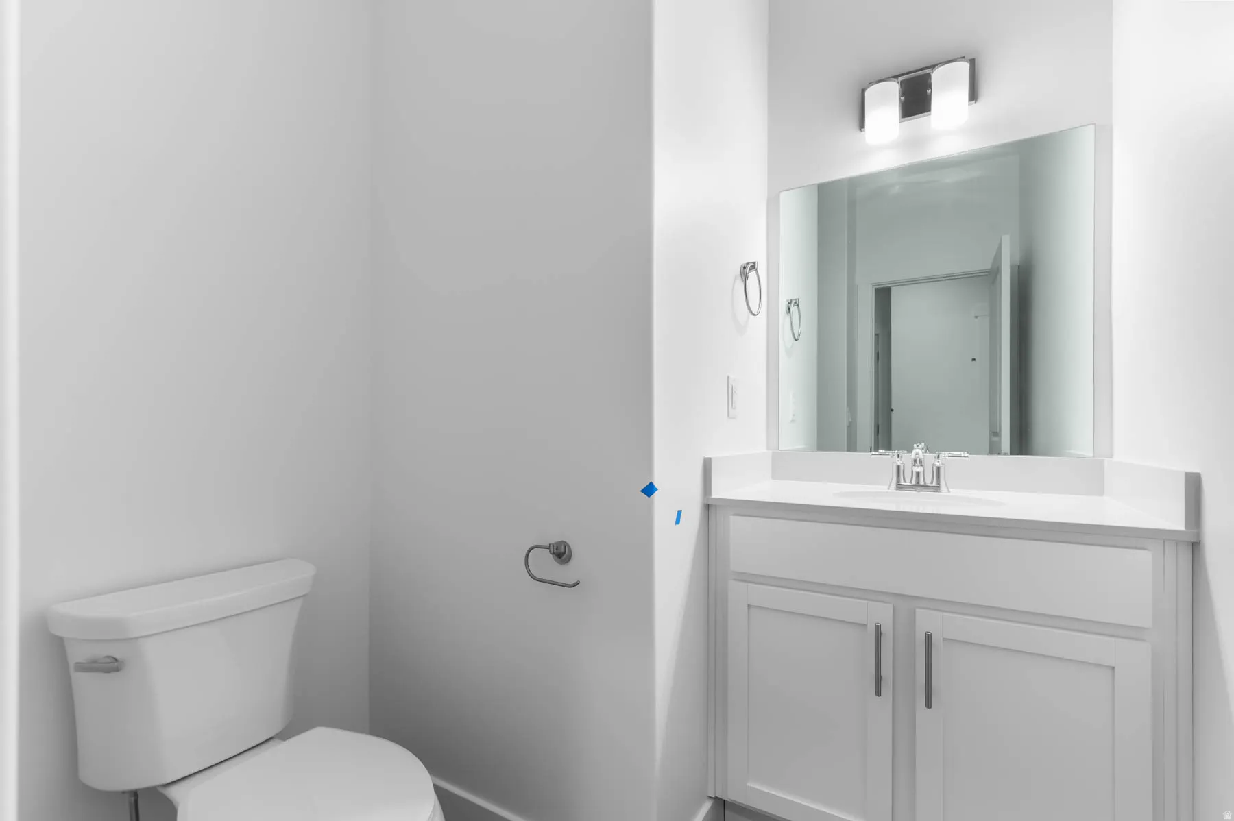 Contemporary vanity with a flat-panel cabinet, integrated sink, and wall-mounted mirror