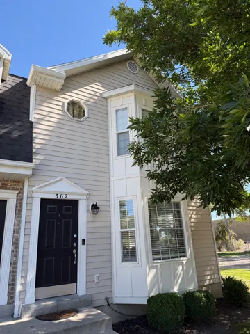 Siding exterior with a bay window, an octagonal window, and an exterior light fixture