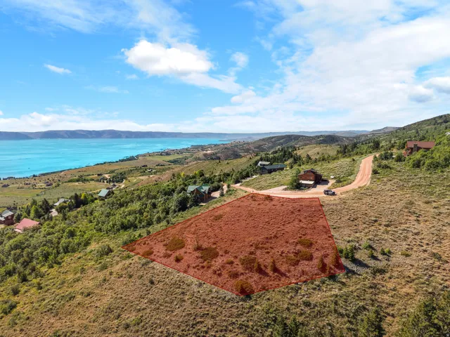 Expansive hillside lot with a lake backdrop and established surrounding properties
