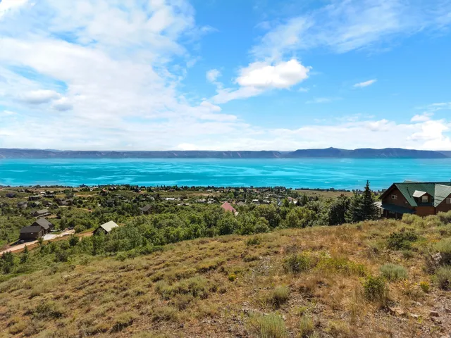 Expansive elevated terrain offering broad water and distant mountain scenery