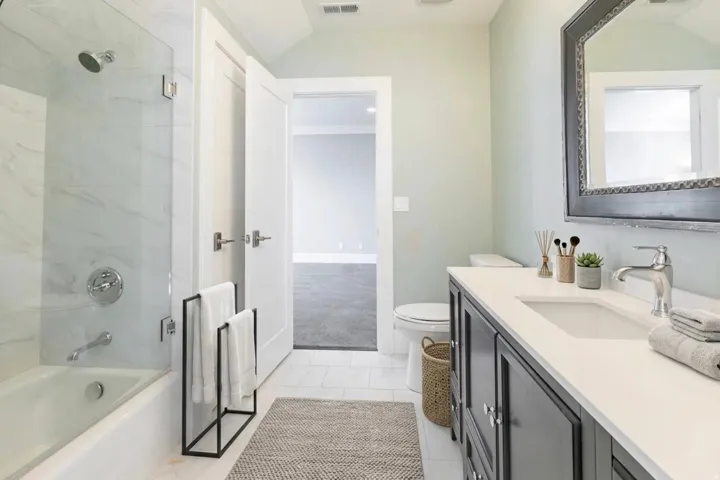 Built-in tub with a glass shower enclosure and a rain shower head