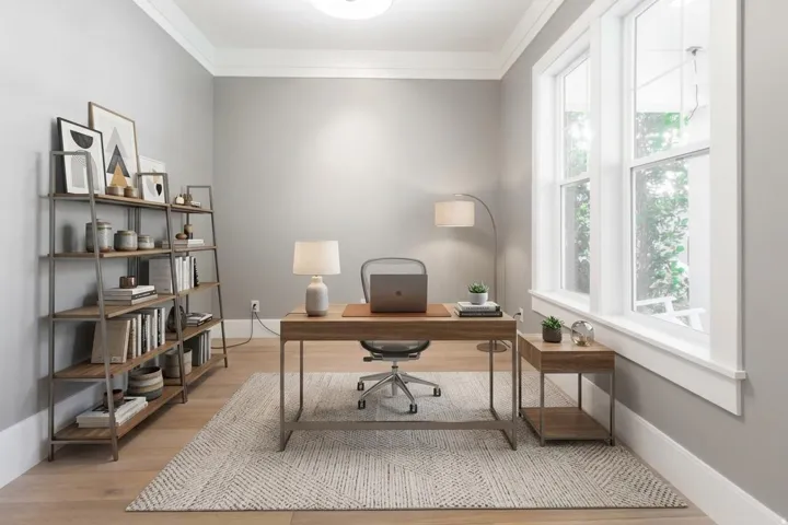 Light wood-finish flooring, two large windows, white trim, and a ceiling light fixture