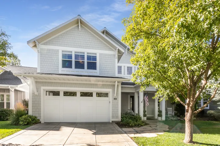 Two-story residence featuring shingle siding and a gabled roofline
