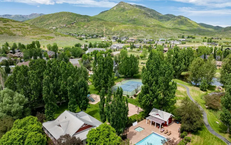 Community swimming pool, tennis court, playground, walking paths, and mountain scenery