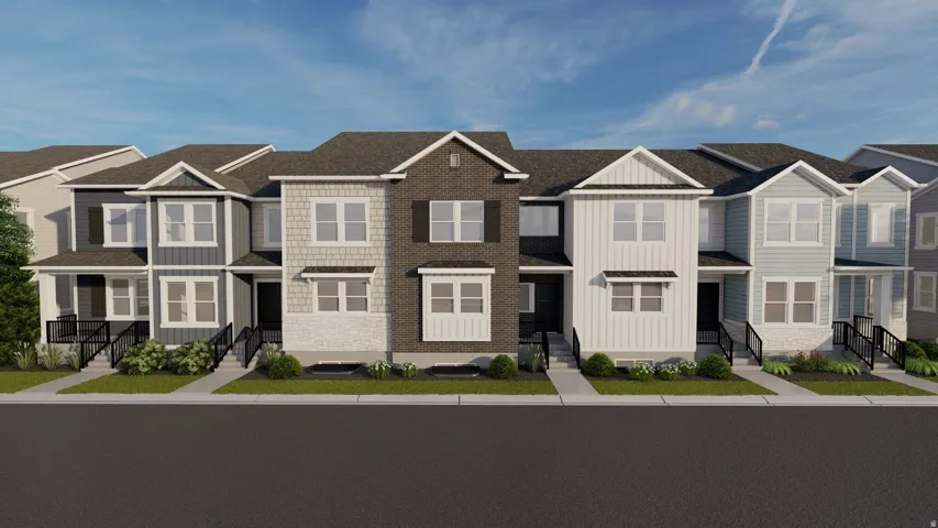 Modern townhome community featuring clean-lined architecture with varied exterior finishes including brick and fiber cement siding, peaked rooflines with architectural detail, multi-pane windows, and front-loaded garages