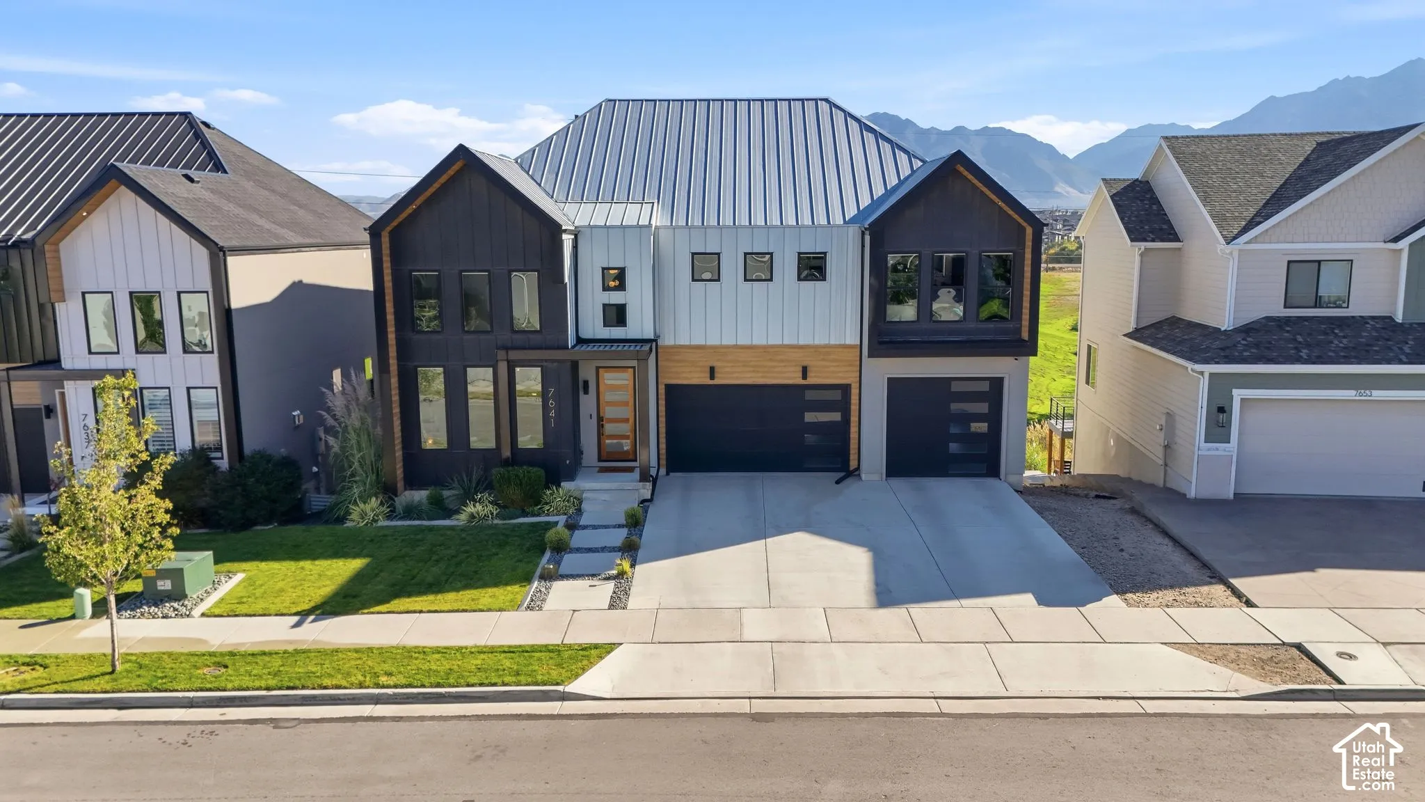 Modern architectural design featuring varied siding materials and a metal roof