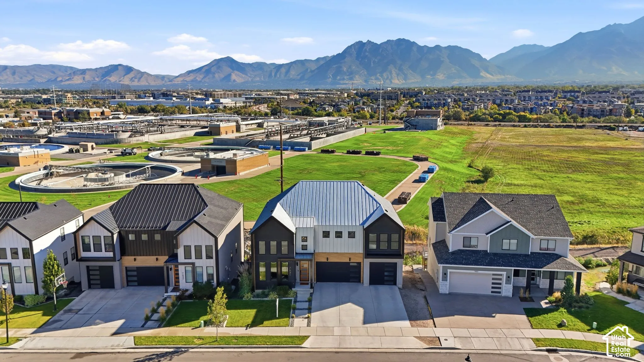 Modern residential architecture with varied exterior finishes, attached garages, and paved driveways