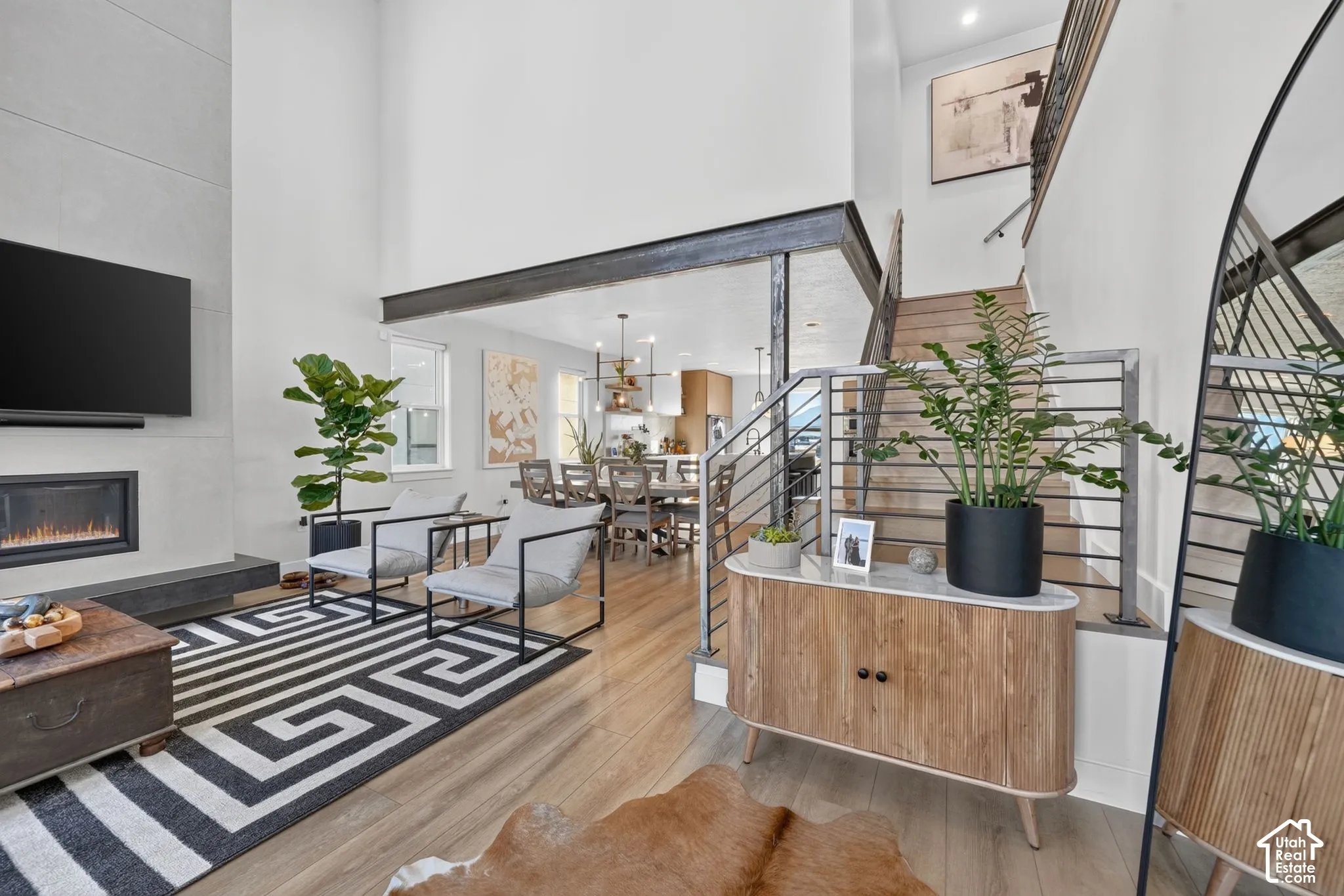 Soaring ceiling height in the living area, featuring a built-in fireplace with a stone-finish surround