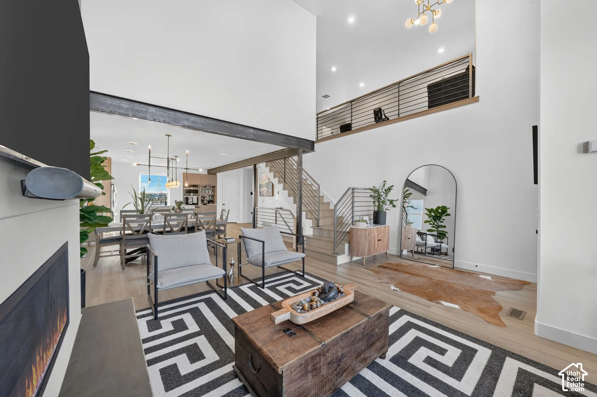 Open-concept living space with high ceilings and wood-finish flooring