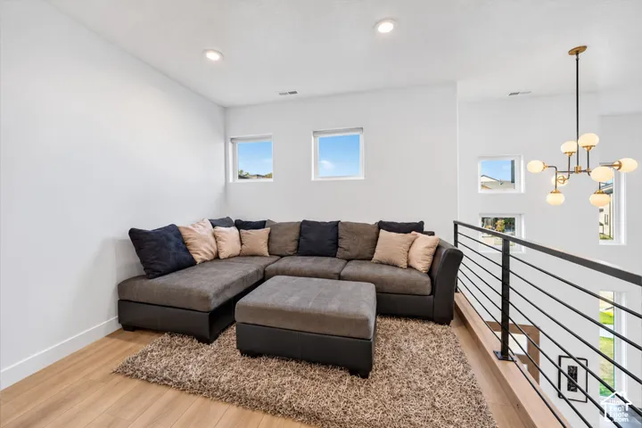 Loft area featuring wood-finish flooring and recessed lighting