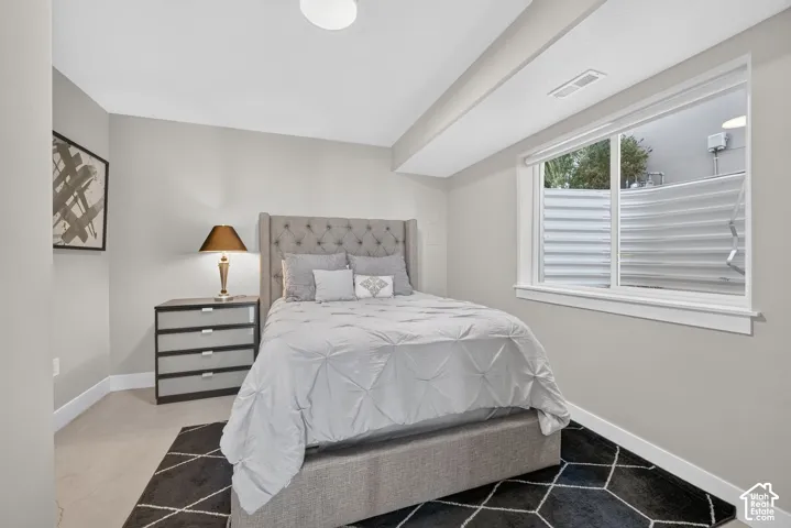 Recessed ceiling light, carpeted flooring, and a large window with white trim