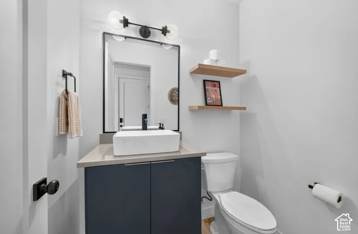 Modern vanity with a rectangular vessel sink, coordinating countertop, and two-door storage