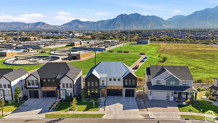 Modern residential architecture with varied exterior finishes, attached garages, and paved driveways