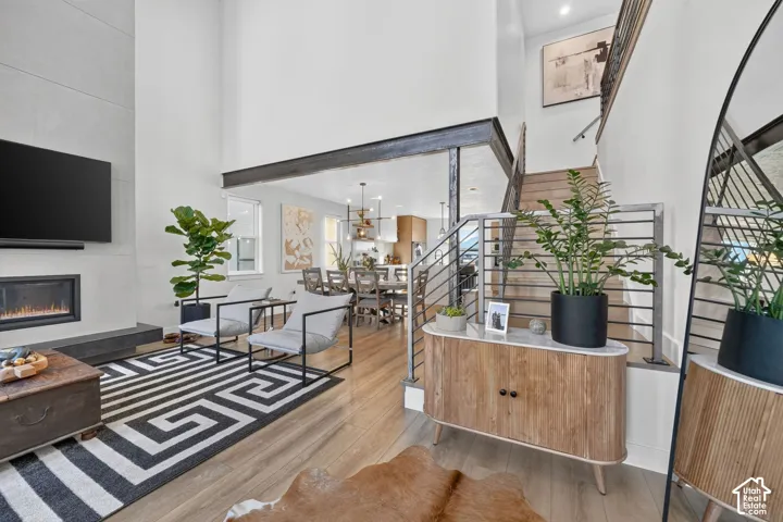 Soaring ceiling height in the living area, featuring a built-in fireplace with a stone-finish surround