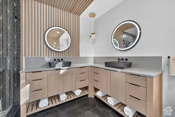 Dual vessel sinks set atop expansive countertops