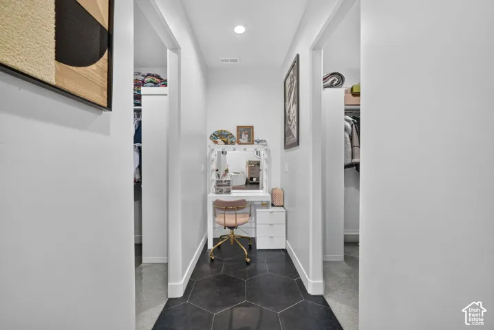 Hexagonal floor tiling, recessed lighting, and white trim