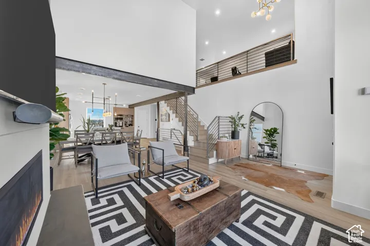 Open-concept living space with high ceilings and wood-finish flooring