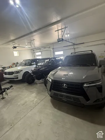 Spacious garage with multiple overhead doors and an exposed concrete floor