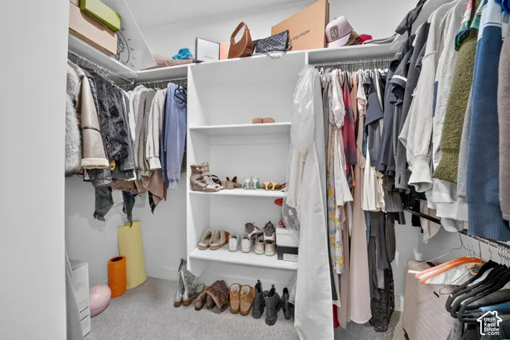 Integrated closet system featuring white shelving and hanging rods