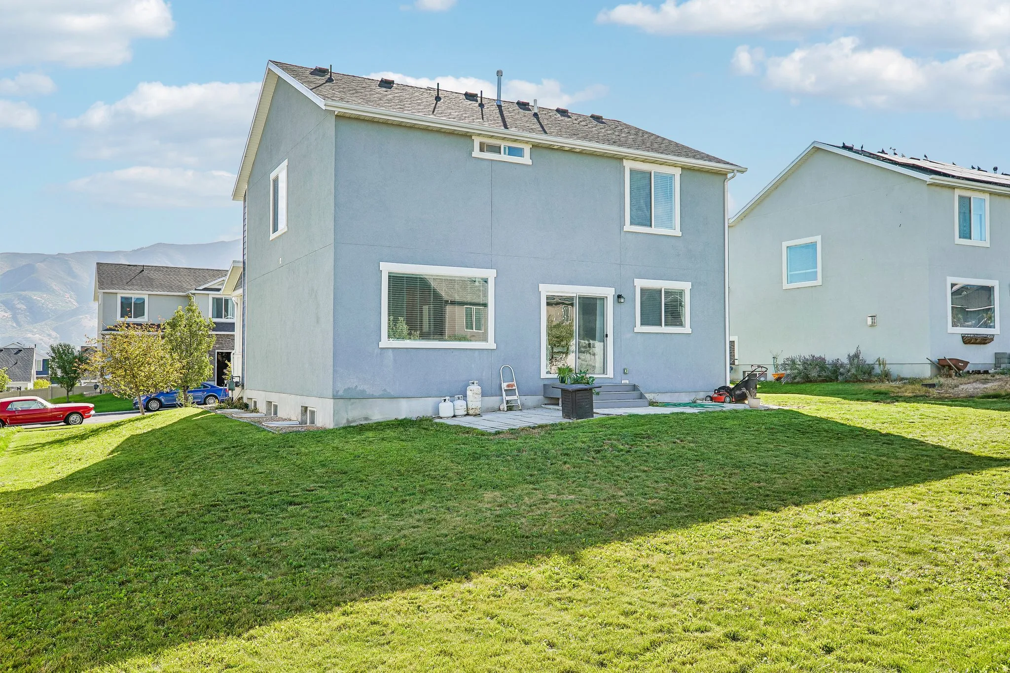 Stucco exterior with white trim windows and a sliding glass patio door