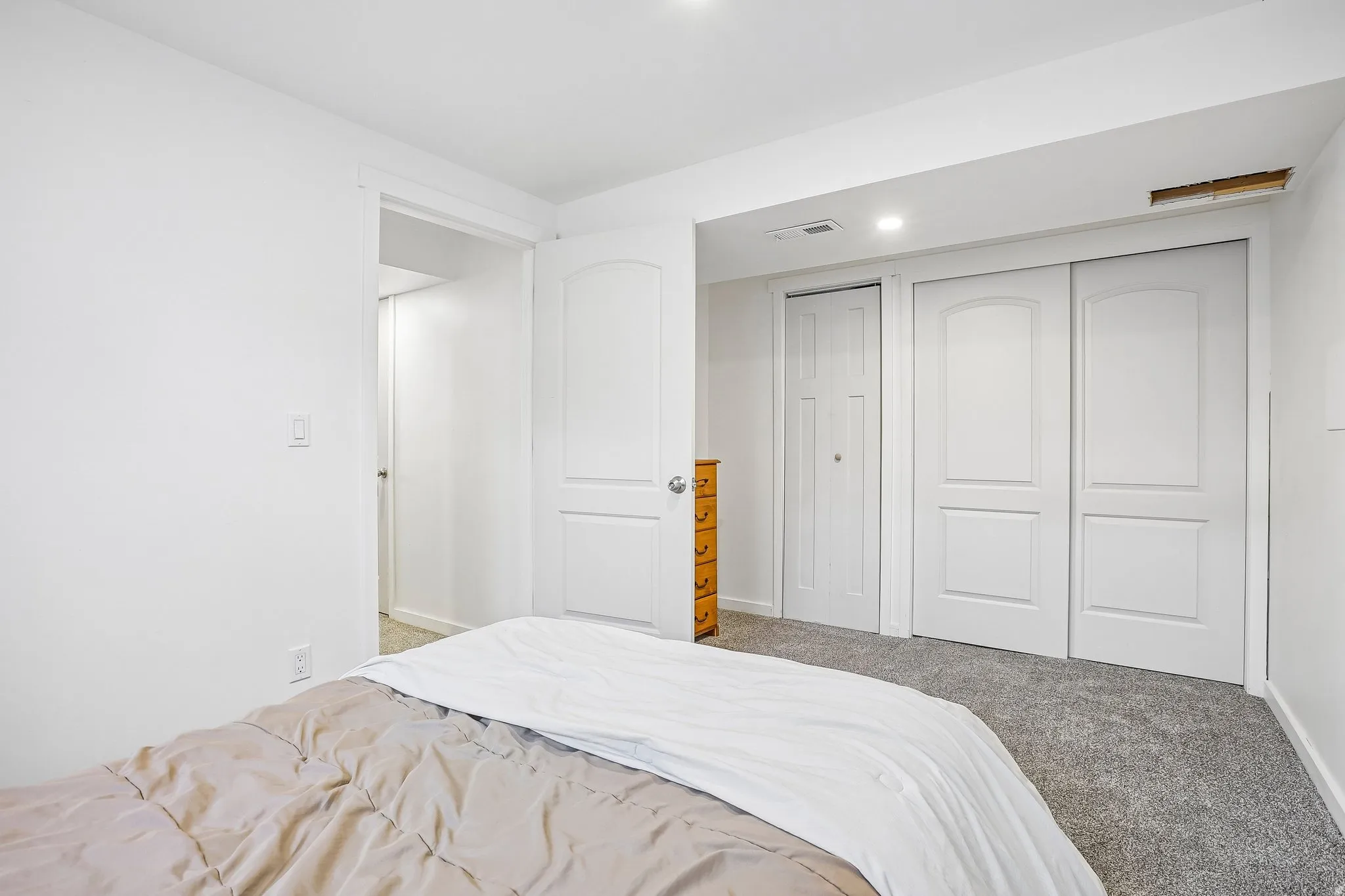 Plush carpet flooring, recessed lighting, and white interior doors