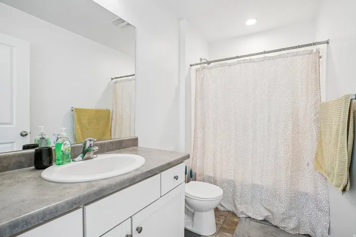 White vanity with an integrated sink and chrome faucet