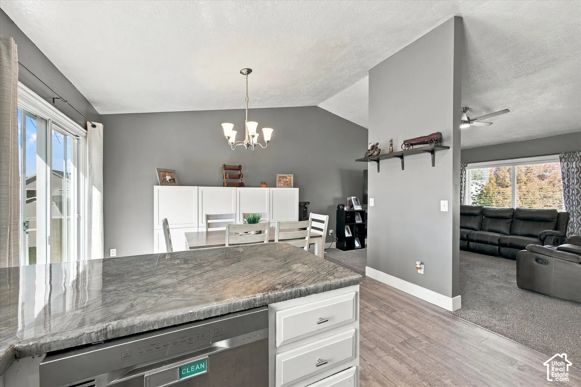 Kitchen island with a polished countertop and integrated dishwasher