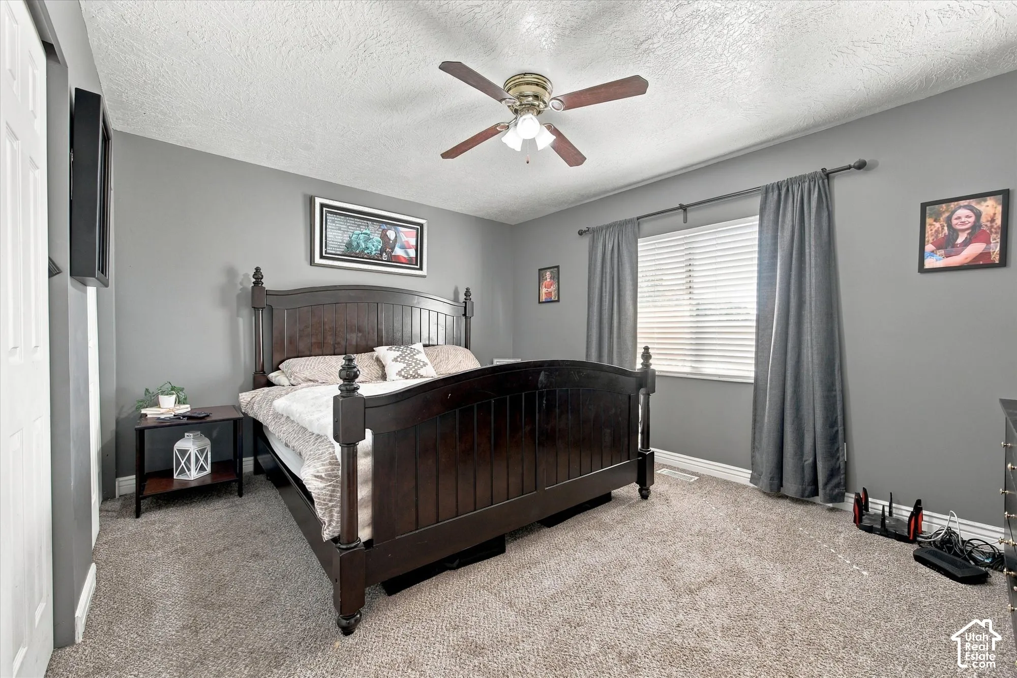 Carpeted flooring, window with blinds, ceiling fan with integrated lighting, and painted walls