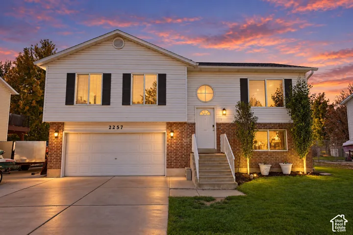 Two-story exterior with white siding and brick accents