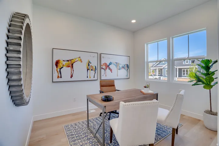 Recessed lighting, wood-finish flooring, and white walls