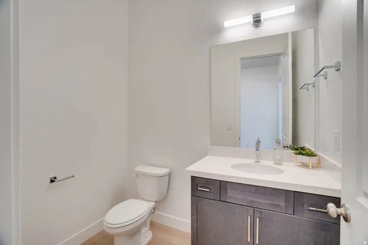 Vanity with an integrated sink, light-toned countertop, and dark wood-finish cabinetry