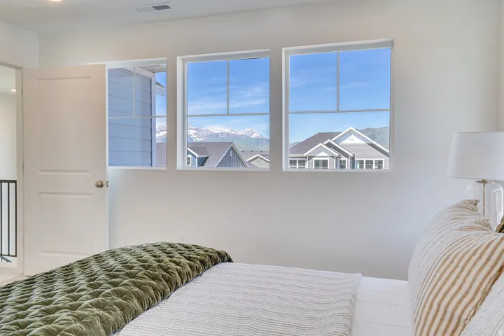 Three large windows offering mountain scenery