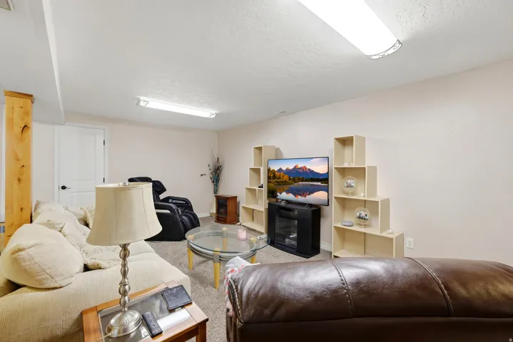 Recessed lighting and ceiling-mounted light fixtures illuminate this carpeted room