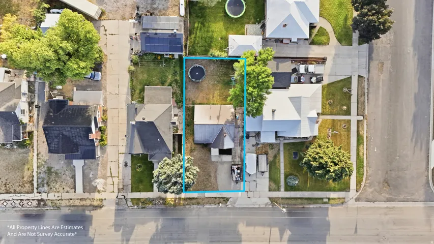 Aerial perspective showcasing the property's footprint, surrounding residential landscape, and street access
