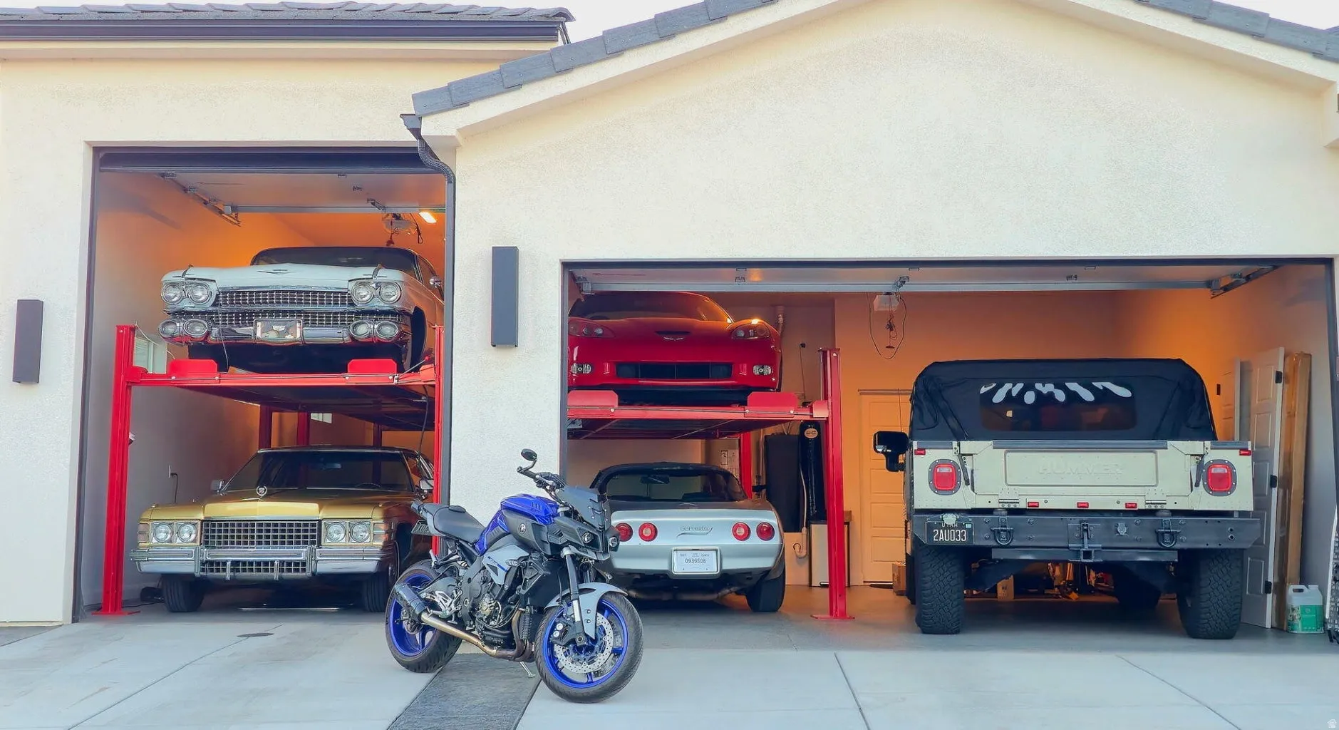 Attached two-car garage with overhead doors and interior lighting