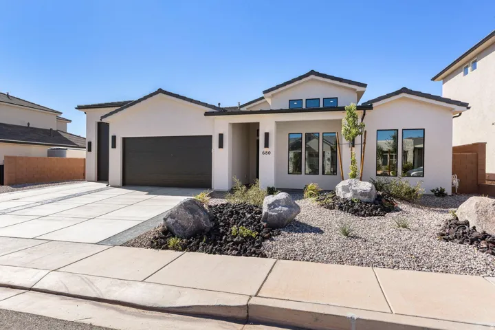 Contemporary stucco exterior with dark trim windows