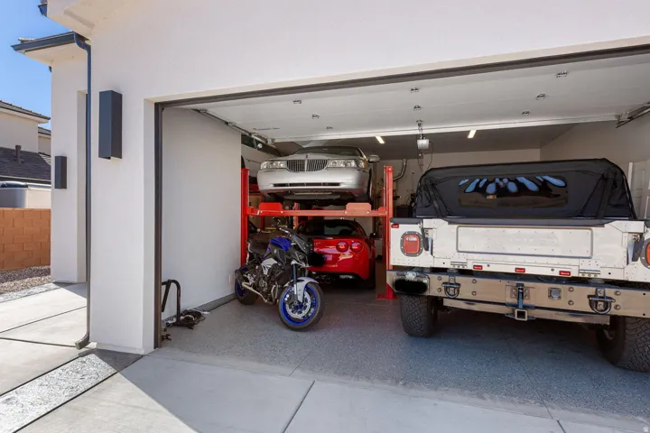 Spacious garage with an epoxy-coated floor and overhead fluorescent lighting