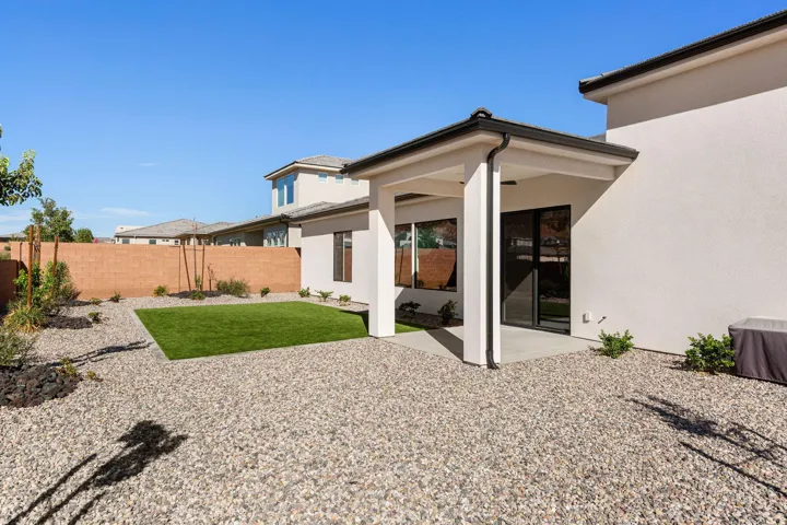 Covered patio with recessed lighting, stucco exterior, and black-framed sliding glass door