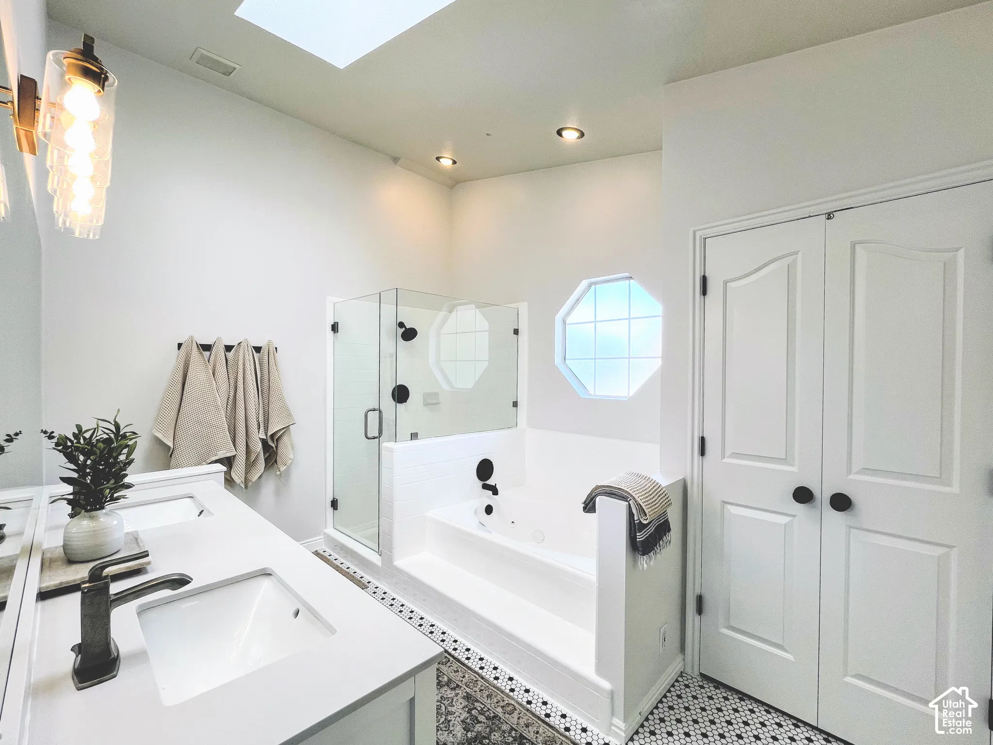 White vanity with dual integrated sinks and bronze-finish fixtures